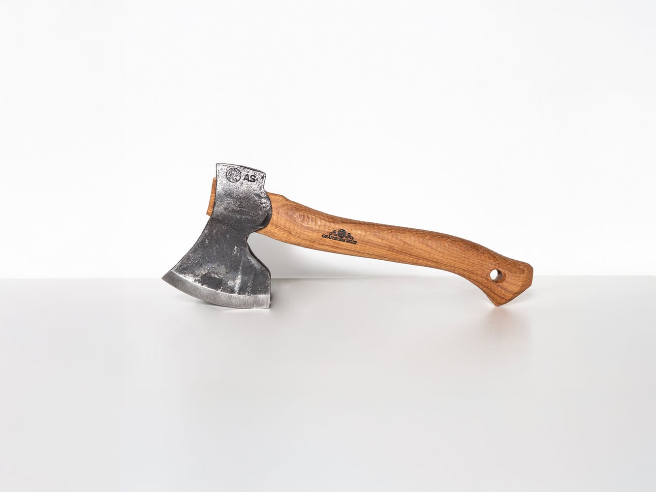 Small axe with a wooden handle on a white background
