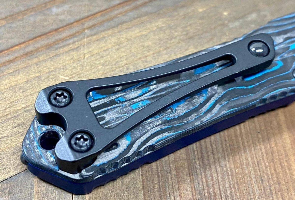 Heretic Knives Manticore S OTF Auto 2.55" MagnaCut Black DLC Recurve Blade, Blue Aluminum Handle with Blue CamoCarbon - NORTH RIVER OUTDOORS