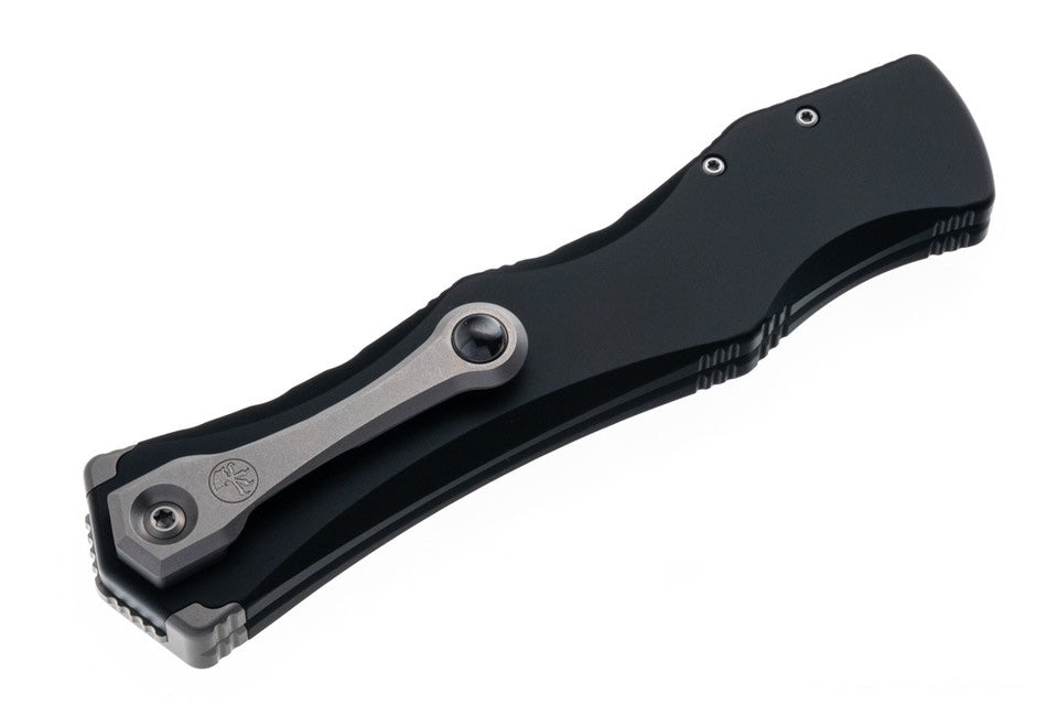 Black and silver folding knife on a white background