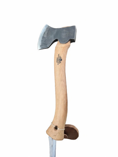 A hand axe with a natural wood handle and a dark steel head, shown vertically against a plain white background. A small black logo is printed on the handle.