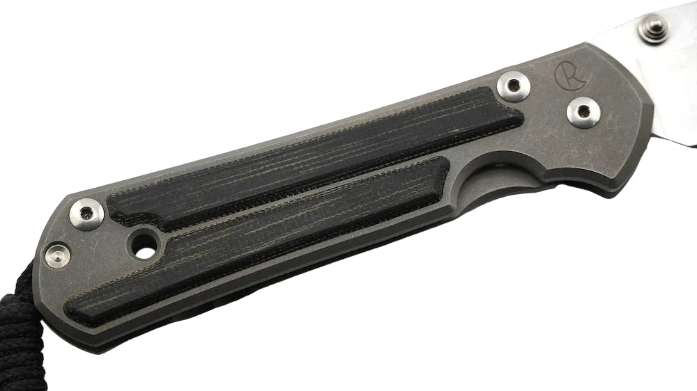 A close-up of a folding knife handle made of dark gray and black textured materials, with a silver metal blade partially visible on a white background.