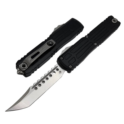 Black folding knife with a metallic blade on a light gray background