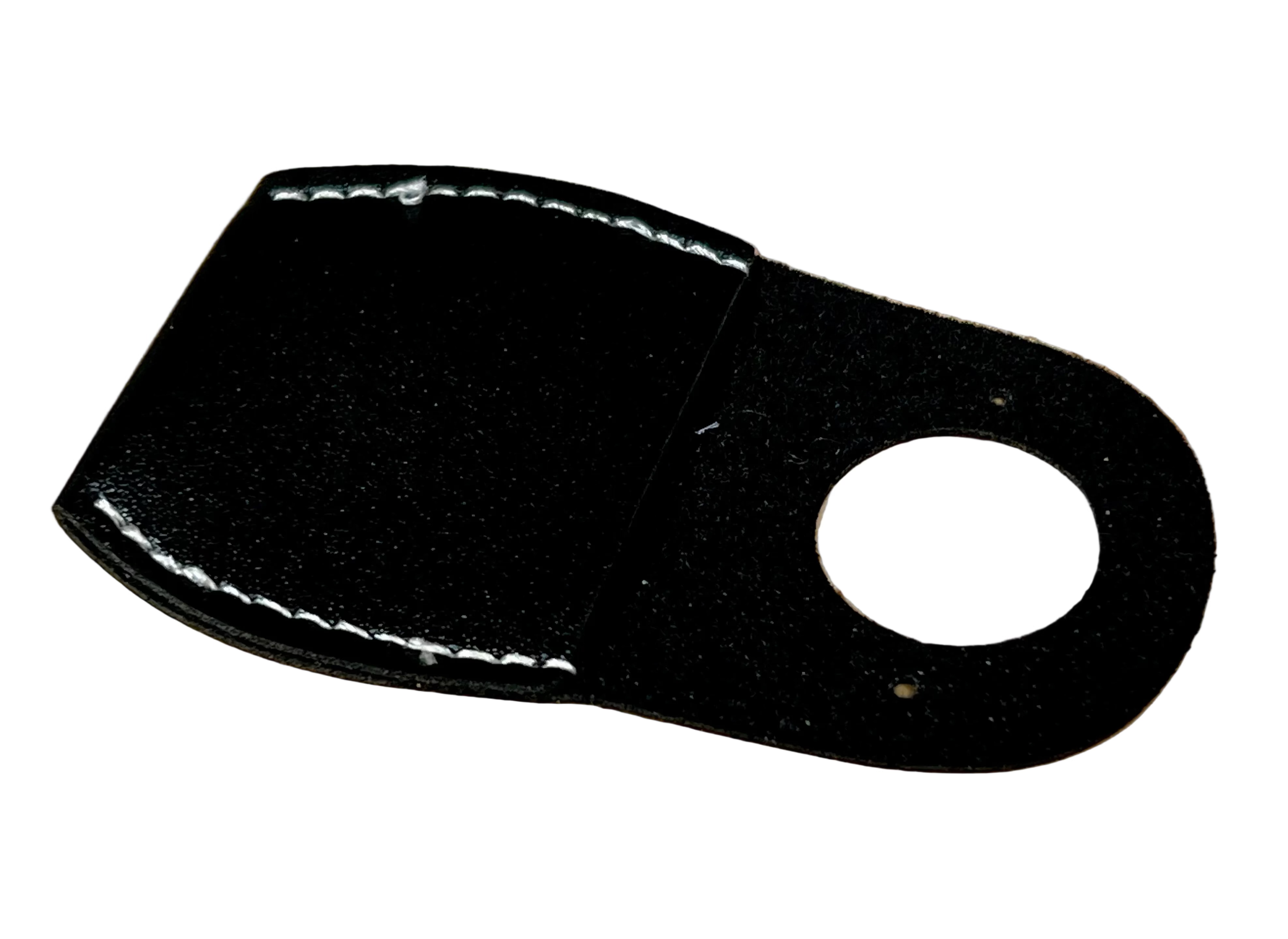 Black leather patch with a circular cutout on a wooden surface