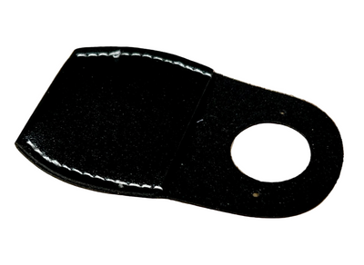 Black leather patch with a circular cutout on a wooden surface