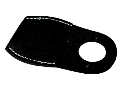 Black leather patch with a circular cutout on a wooden surface