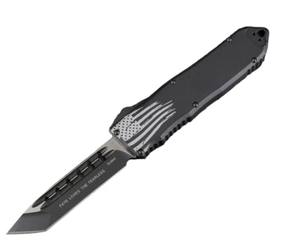 Folding knife with American flag design on a textured gray background