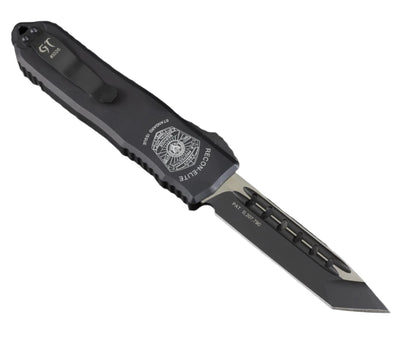 Black tactical knife with visible brand logo on a gray textured background