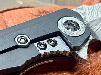 Heretic Knives Custom Wraith Manual T/E DLC Titanium Handle w/ Vegas Forge Wood Grain Damascus Inlay Hand Compound Ground Vegas Forge Wood Grain San Mai Damascus Blade - NORTH RIVER OUTDOORS