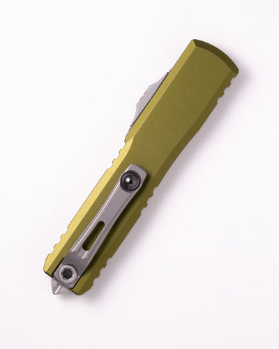Green folding knife on a white background