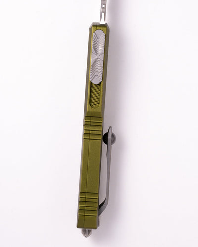 Green pocket knife with a silver blade on a white background