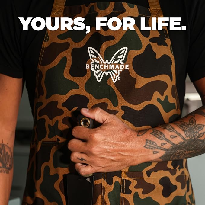 A person wearing a Benchmade camouflage apron over a black T-shirt, holding a black object in front of the apron. Large white text at the top reads 'YOURS, FOR LIFE.