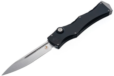 Folding knife with black handle and silver blade on a white background
