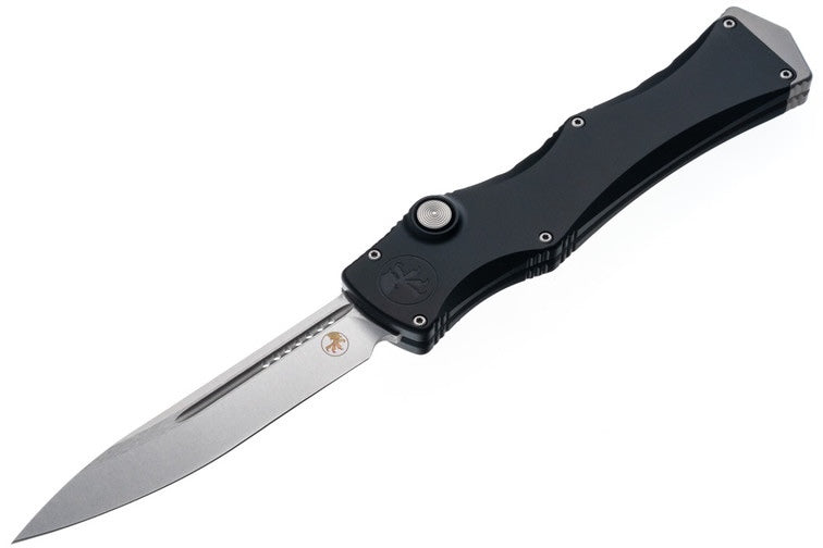 Folding knife with black handle and silver blade on a white background
