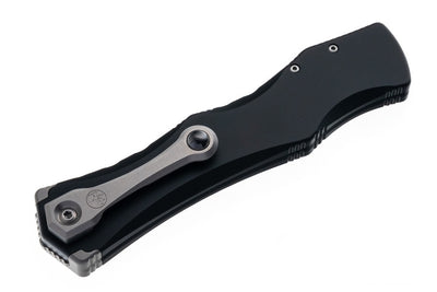 Black and silver folding knife on a white background